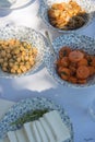 Bowls with healthy starters as chickpeas, carrots and cheese. Beautiful crockery with a pattern of small flowers