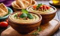 Bowls of hummus with chickpeas and parsley