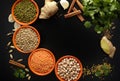 Bowls with legumes and indian spices, fresh and dried on black b Royalty Free Stock Photo