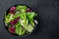 Bowls with mixed shredded salad lettuce leaves, on black background, top view flat lay  with copy space for text Royalty Free Stock Photo