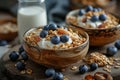 Bowls of oatmeal muesli with natural yogurt and blueberries on a wooden table