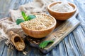 Bowls of oats, oat flour and wooden scoop.