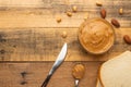 Bowls of peanut butter and peanuts on a dark wooden background from top view, rich breakfast Royalty Free Stock Photo