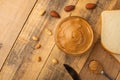 Bowls of peanut butter and peanuts on a dark wooden background from top view, rich breakfast Royalty Free Stock Photo