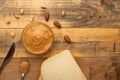 Bowls of peanut butter and peanuts on a dark wooden background from top view, rich breakfast Royalty Free Stock Photo