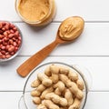 Bowls with peanuts and jar of peanut butter