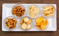 Bowls of pretzels on wooden tray on top
