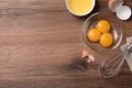 Bowls with raw egg yolks and white on wooden table, flat lay. Space for text Royalty Free Stock Photo