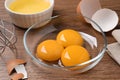 Bowls with raw egg yolks on wooden table, closeup Royalty Free Stock Photo