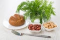 Bowls with red and white beans, bread, dill in glass