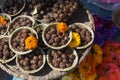 Bowls with saffron water and flowers at Bodhnath stupa in Kathmandu valley, Nepal