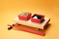 Bowls of soy sauce and beans on stand with chopsticks Royalty Free Stock Photo