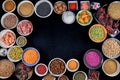 Bowls with species on black background. Hibiscus, yellow lentils, green lentils, pink arooz, star anise, chickpeas, sesame, oat se