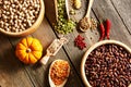 Bowls and spoons of various legumes