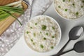 Bowls with tasty cooked rice on white table