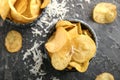 Bowls with tasty crispy potato chips on grey table Royalty Free Stock Photo