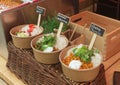 Bowls with to go meals at farmers market. Royalty Free Stock Photo