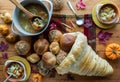 Bowls of turkey soup and a homemade cornucopia made of bread filled with rolls. Royalty Free Stock Photo