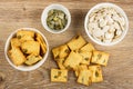 Bowls with unpeeled and peeled pumpkin seeds, bowl with cookies, few cookies on wooden table. Top view Royalty Free Stock Photo