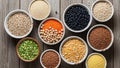 Bowls of various dry legumes and grains are arranged on a wooden Royalty Free Stock Photo