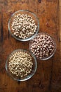 Bowls of various legumes (soybeans, chickpeas, beans) on wooden Royalty Free Stock Photo