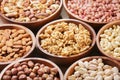 bowls of various mixed nuts on wooden background