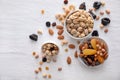 Bowls with various tasty nuts and dried fruits on wooden table