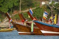 Bows of cheerful and colorful long tail boats moored