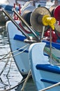 Bows of a greek fishing boats in a harbor at morning