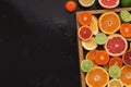 Variety of ripe citruses on black background Royalty Free Stock Photo