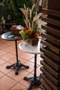 Box with business cards on a black round table, a box with hydrangea, celosia flowers, elderberry branches and reeds