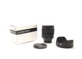 Box, cap, hood and brand-new advanced aspherical landscape lens with cap made in Japan for DSLR full frame camera photography Royalty Free Stock Photo