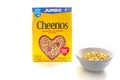 A box of cereal Cheerios with a bowl of cereal on the side on a white background Royalty Free Stock Photo