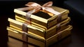 Box of chocolates in the form of a gold bar, gift boxes on the table