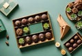 a box with chocolates on it on green background with plants and other things Royalty Free Stock Photo