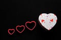 Box of chocolates red and pink hearts on black background, Valentine`s day, advertising banner Royalty Free Stock Photo