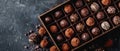 A box of chocolates sits atop one table, nearby, another table holds a pile of chocolates Royalty Free Stock Photo