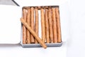 Box of cigarillos on a white background. On the box is one cigarillo Royalty Free Stock Photo