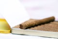 Box of cigarillos on a white background. On the box is one cigarillo Royalty Free Stock Photo