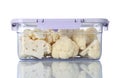 Box with cut fresh raw cauliflowers on white