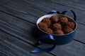 Box with delicious chocolate truffle candies on blue wooden table Royalty Free Stock Photo