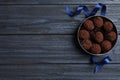 Box with delicious chocolate truffle candies on blue wooden table, flat lay. Space for text Royalty Free Stock Photo