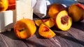 A box of delicious fresh peaches on the table. Peaches in an old rustic box on a dark wooden table Royalty Free Stock Photo