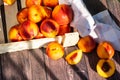 A box of delicious fresh peaches on the table. Peaches in an old rustic box on a dark wooden table Royalty Free Stock Photo