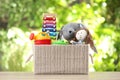 Box with different child toys on table