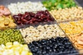 Box of different whole grains beans and legumes seeds lentils and nuts colorful snack background top view - Collage various beans Royalty Free Stock Photo