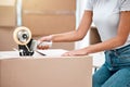 This box is done. an unrecognisable woman kneeling and using sellotape to seal boxes before moving. Royalty Free Stock Photo