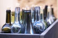 Box with empty wine bottles in defocus, concept of drunkenness