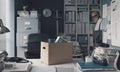 Box filled with personal belongings on the office desk