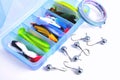 Box for fishing accessories with silicone baits inside, Jig hooks, braided reel on a white background Royalty Free Stock Photo